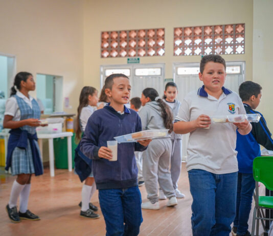 Alimentación escolar llega a 1 038 estudiantes en zonas urbana y rural de Guatapé 2026-01-28 El municipio de Guatapé inició la ejecución del Programa de Alimentación Escolar (PAE) en todas las sedes de la Institución Educativa Nuestra Señora del Pilar, con atención a 1 038 estudiantes de las zonas urbana y rural. El programa se desarrollará durante 111 días calendario. En el área urbana se entrega complemento alimentario, mientras que en la zona rural se suministran refrigerio y almuerzo, de acuerdo con las jornadas escolares y las condiciones de acceso de cada comunidad educativa. La operación del PAE está a cargo de 16 manipuladoras de alimentos con contrato vigente y dotación completa de menaje, lo que permite asegurar los procesos de preparación y entrega de las raciones a los estudiantes. Otras noticias: Avianca pone en operación Business Class en todas sus rutas | MiOriente Copia de DSC07814 Como parte del fortalecimiento del programa, en 2025 el municipio destinó $505 776 744,45 a la remodelación y redistribución del restaurante escolar. La intervención incluyó la adecuación de áreas diferenciadas para preparación caliente y fría, servido, lavado, manejo de residuos y bodegas, así como la incorporación de equipos industriales como refrigeradores, freidoras, horno combi y campanas extractoras. Desde 2026, la cobertura del programa aumentó en 120 cupos, al pasar de 919 a 1 038 estudiantes, lo que representa cerca del 60 % de la población escolar del municipio. El servicio de almuerzo en la zona rural se financia con recursos propios. El PAE se ejecuta mediante un convenio con la Gobernación de Antioquia por $777 832 400, de los cuales el municipio aporta $220 158 104. Estos recursos permiten ampliar la cobertura y sostener el servicio de almuerzo en las sedes rurales, en articulación con la Secretaría de Educación Departamental.